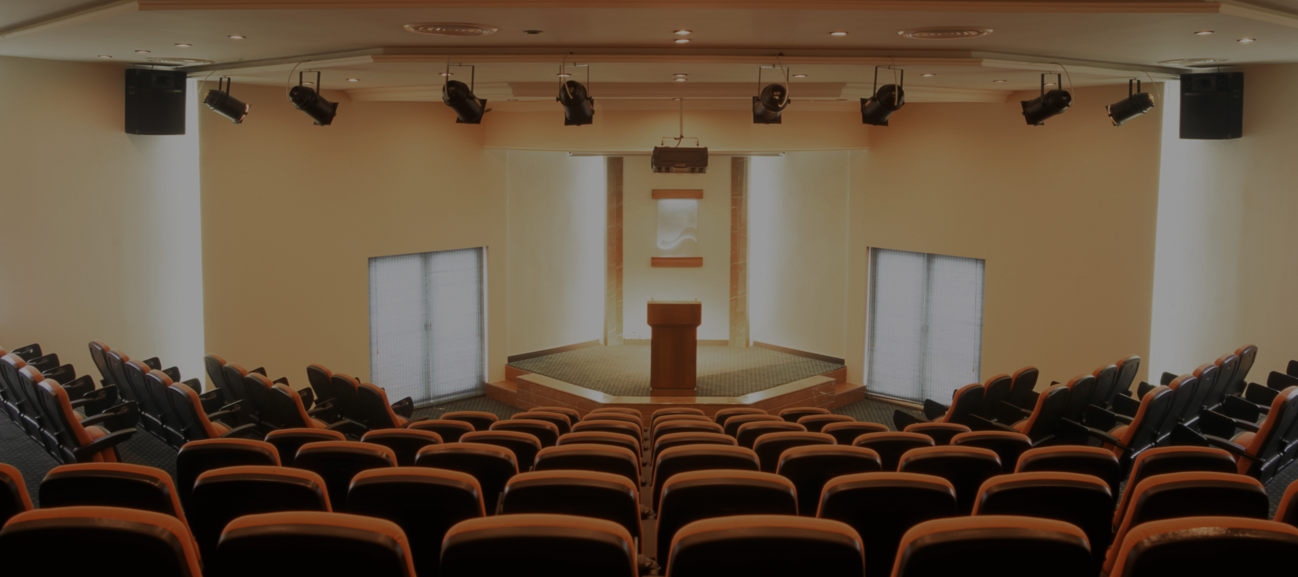 Black and white image of audience with hands raised, capturing concert energy.
