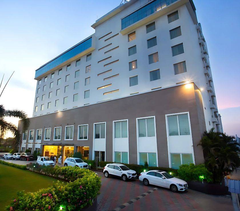 Black and white image of audience with hands raised, capturing concert energy.